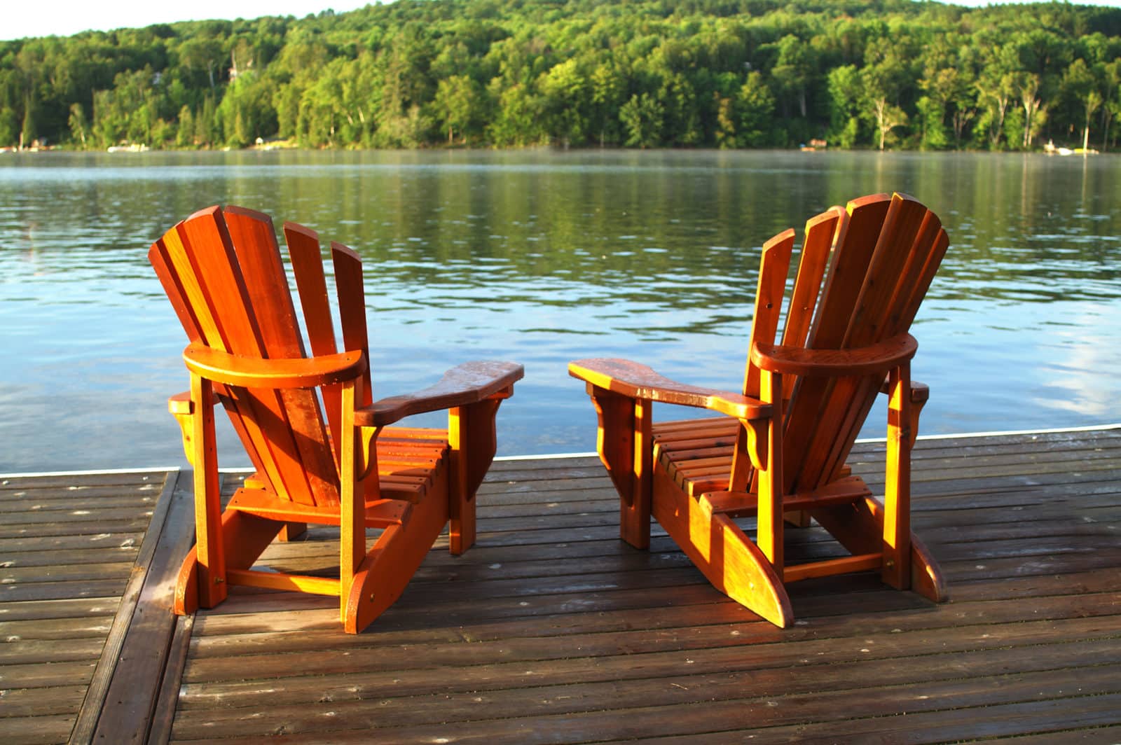 Two Adirondack chairs on deck