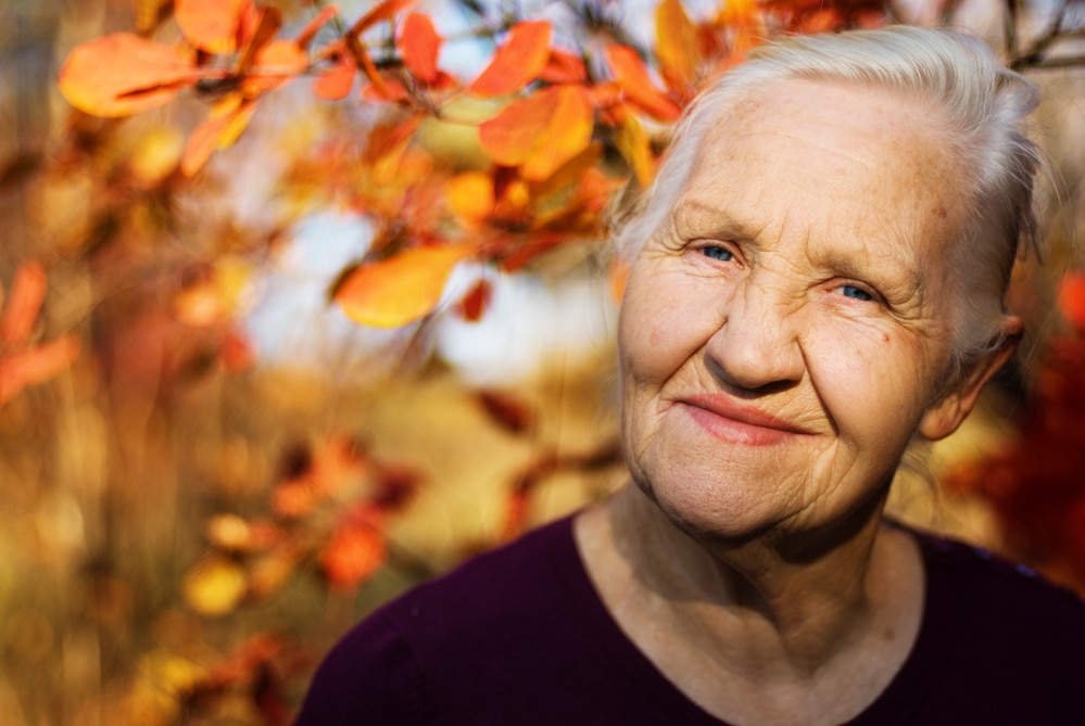 Smiling senior woman outside in autumn