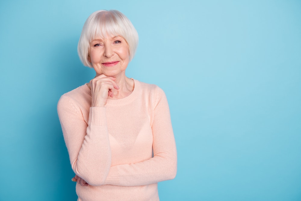 Smiling senior woman on blue background