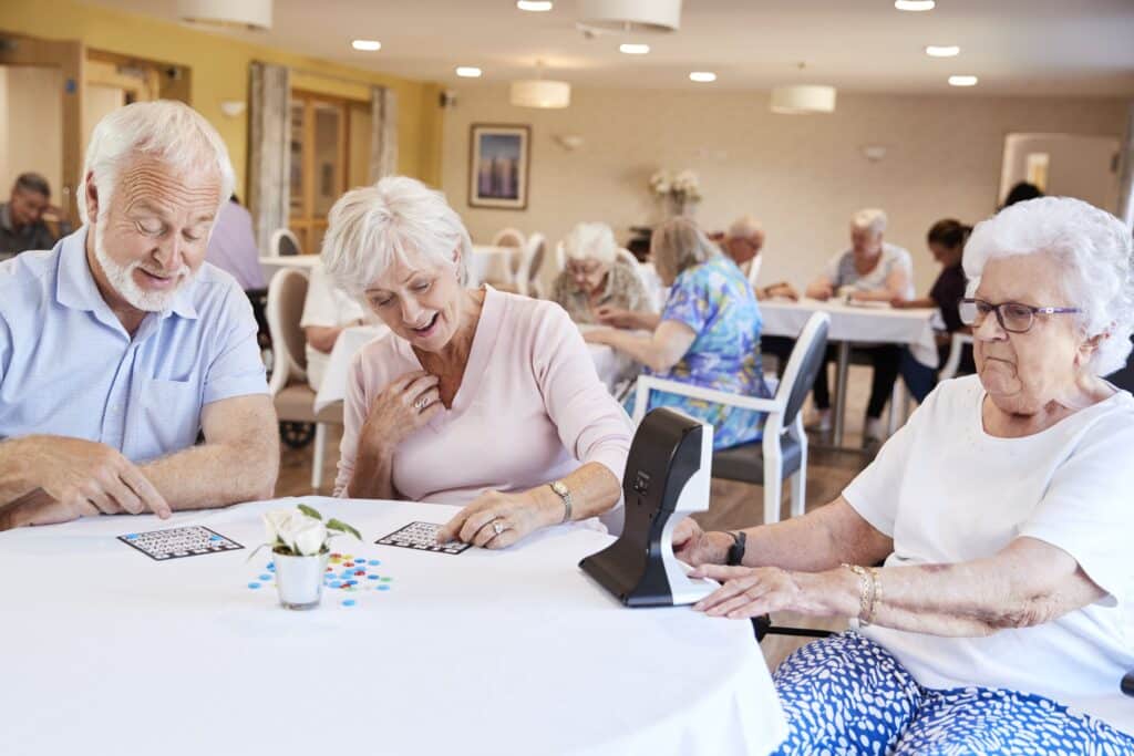 Seniors chatting while playing bingo